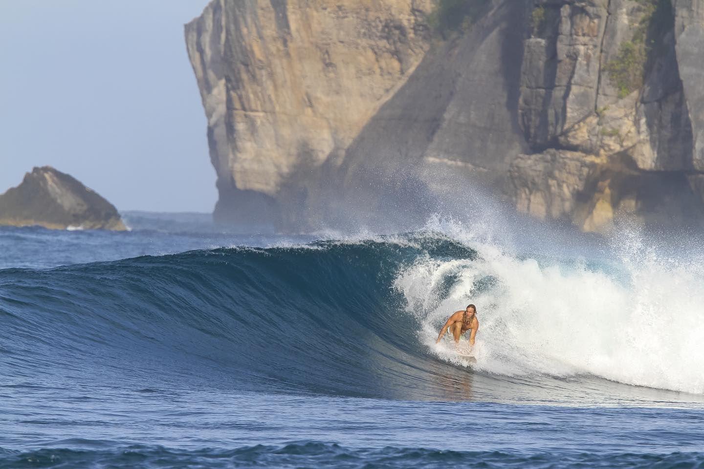 A Surfer Surfing at the best wave Serangan Beach Wave