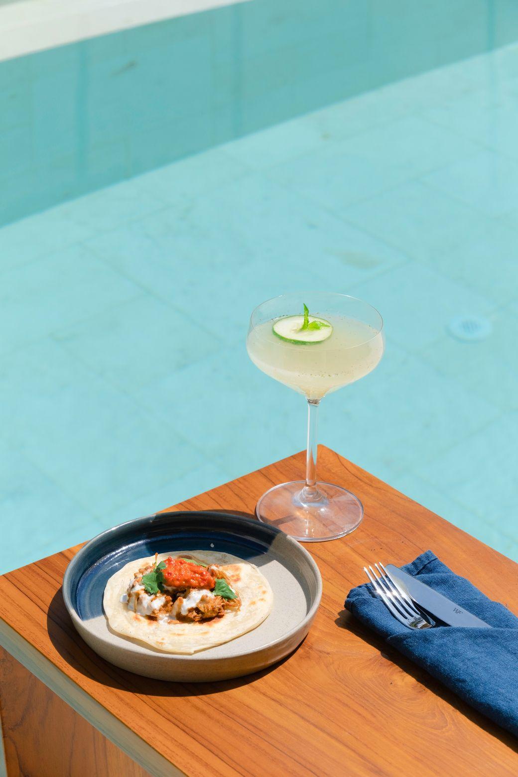A Cocktail and rendang beef taco served pool side at Boni Beach 